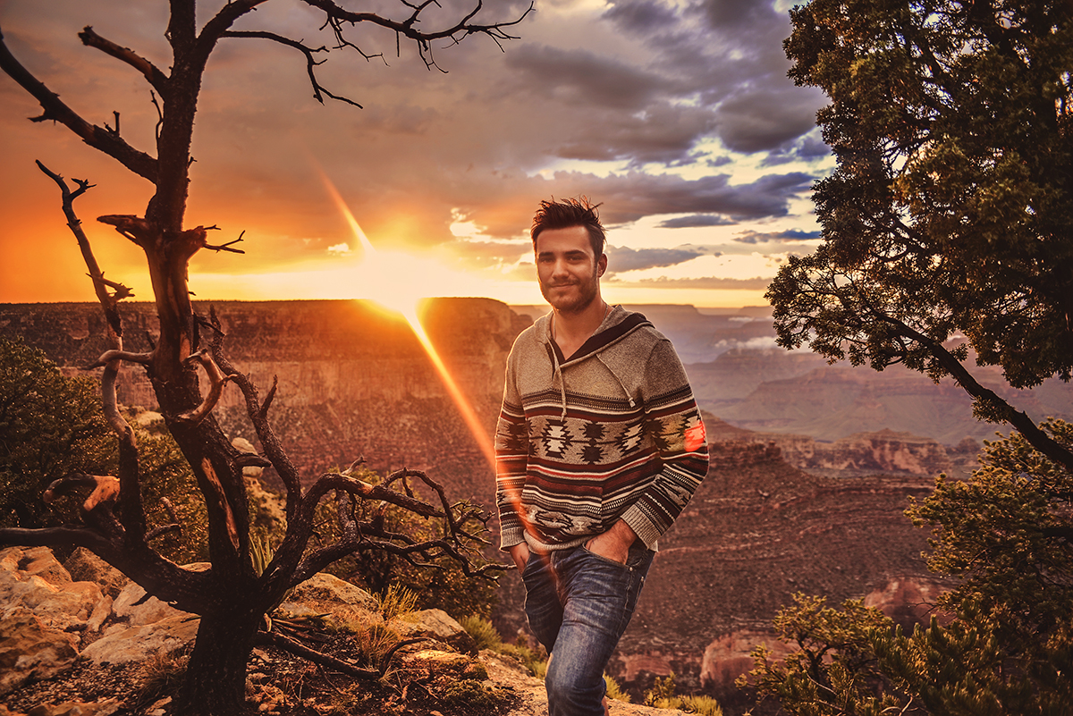 Man in cosy knit standing in front of Grand Canyon Sunset at Mather Point