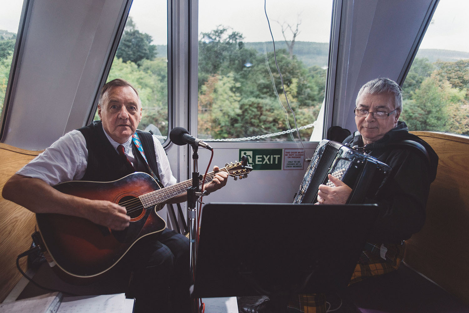 Two scottish musicians in a boat on Loch Ness