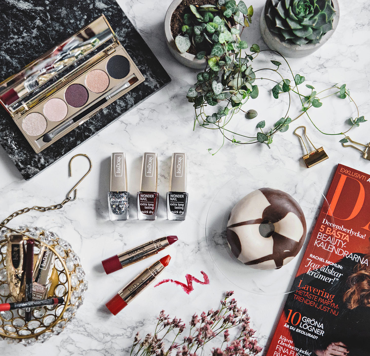 Flatlay with donut, magazine and IsaDora Boho Baroque Holiday Makeup 2016