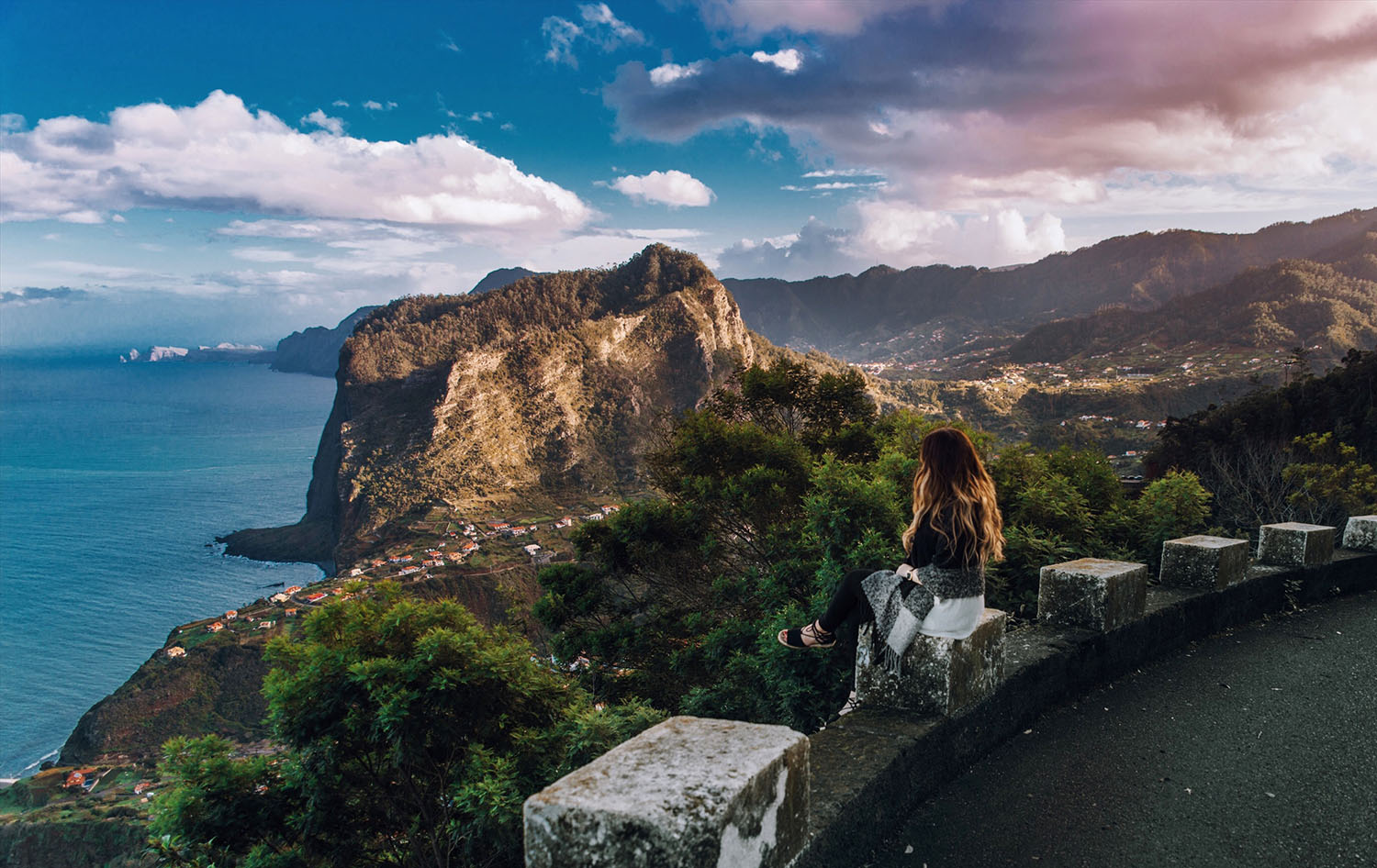 Woman sitting on edge looking out over Madeira's Beautiful Landscape