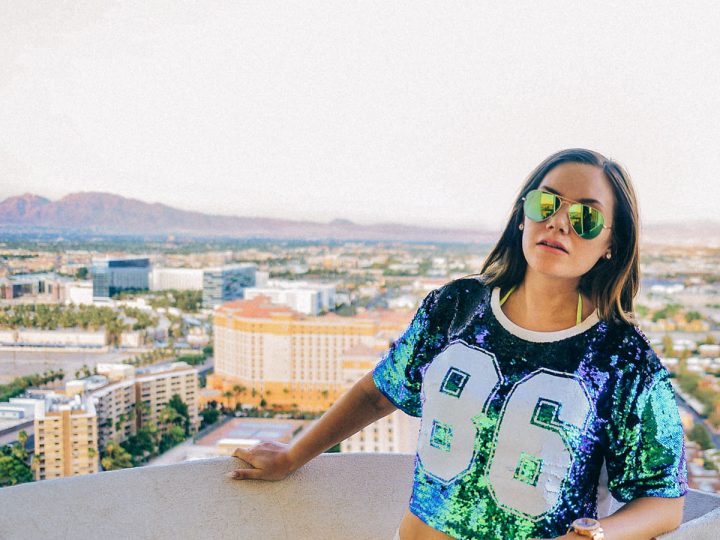 Las Vegas Baby - Woman in sequin top standing before sunset view of Vegas