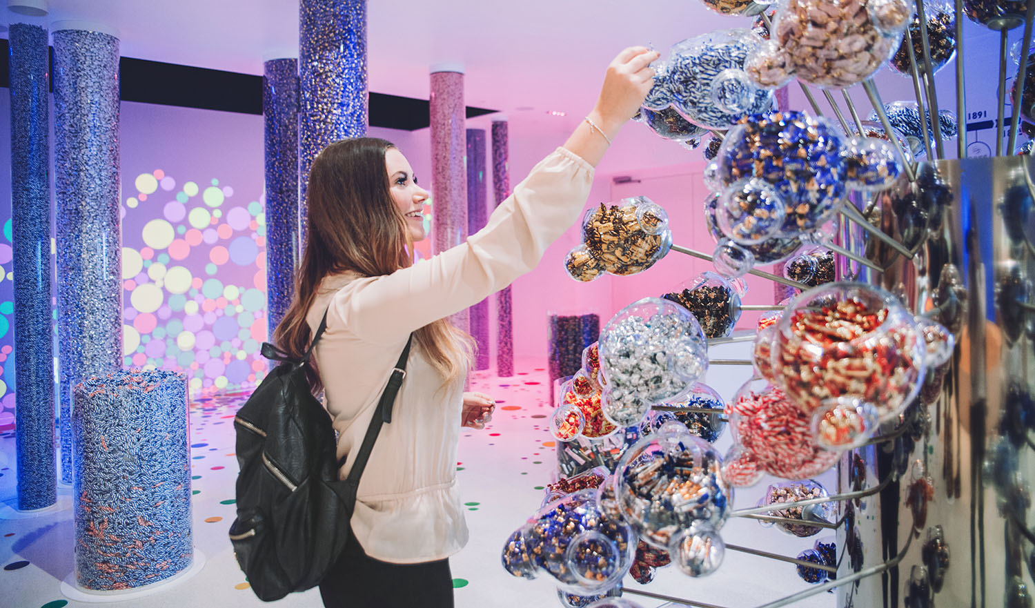 Girl reaching for candy in Fazer Chocolate Factory