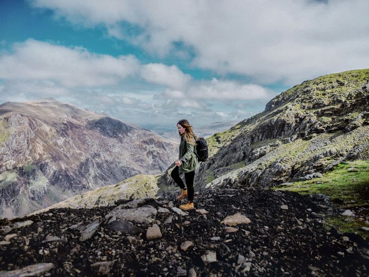 Girl with backpack walking in Clogwyn, Snowdonia National Park in Wales - King Arthur: Legend of the Sword Filming Location in Wales