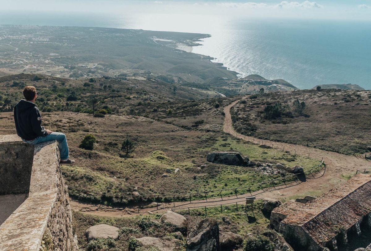 Man sitting on edge at Santuario da Peninha Sintra