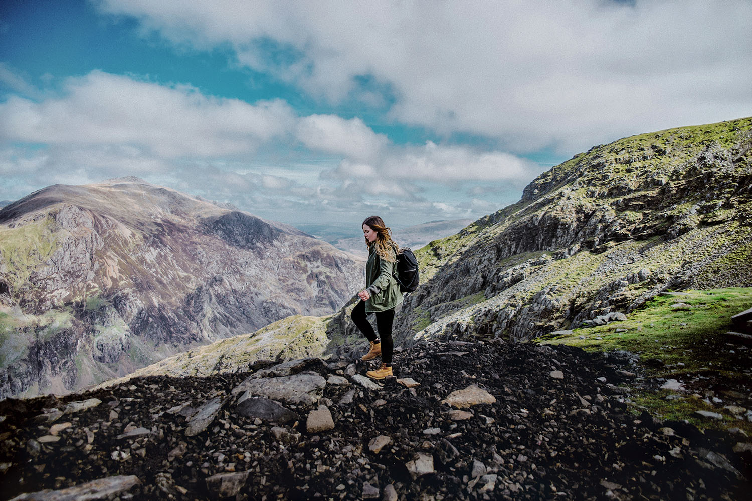 Girl with backpack walking in Clogwyn, Snowdonia National Park in Wales - King Arthur: Legend of the Sword Filming Location in Wales