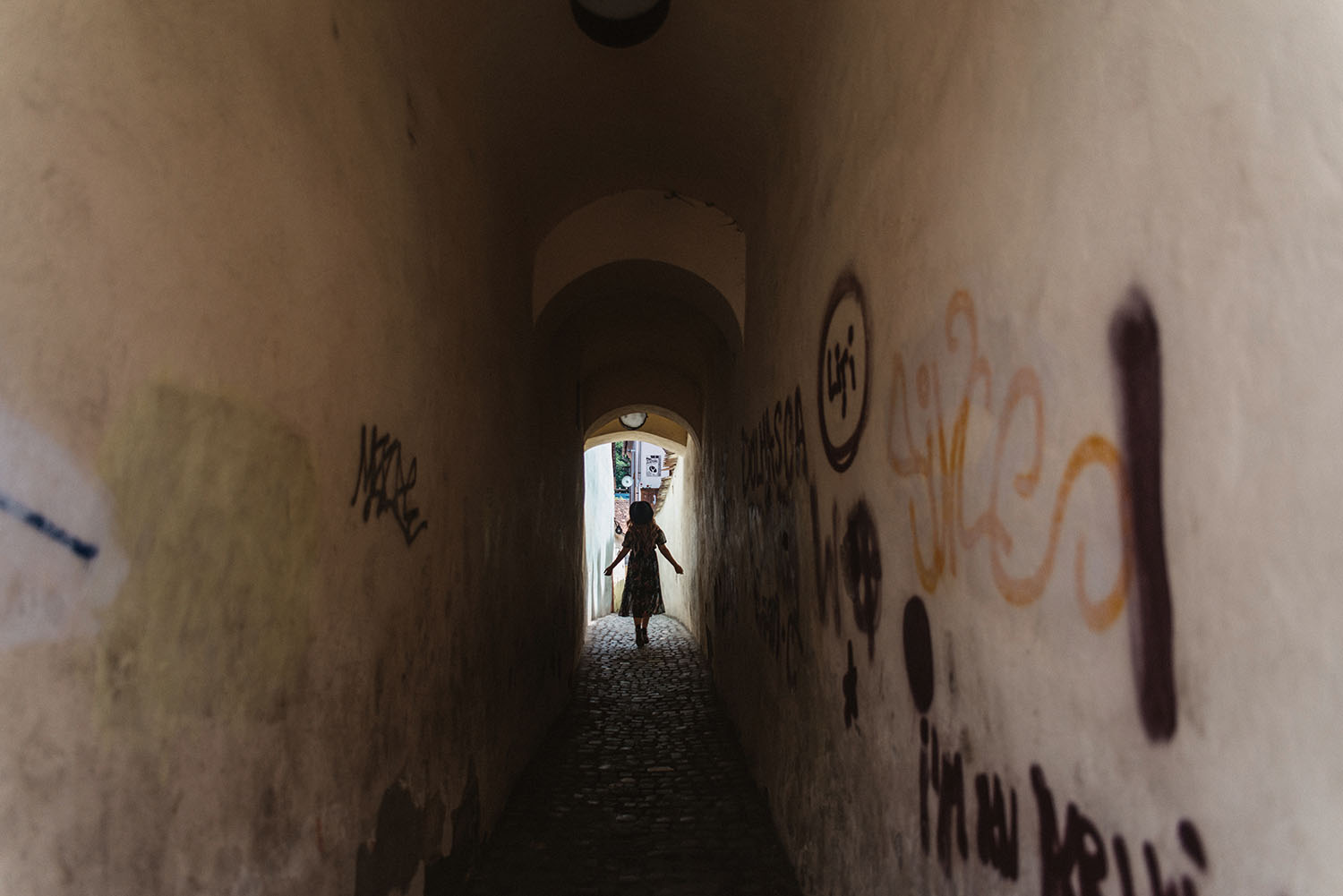 ADARAS walking at Strada Sforii, one of the narrowest streets in the city of Brașov, Romania