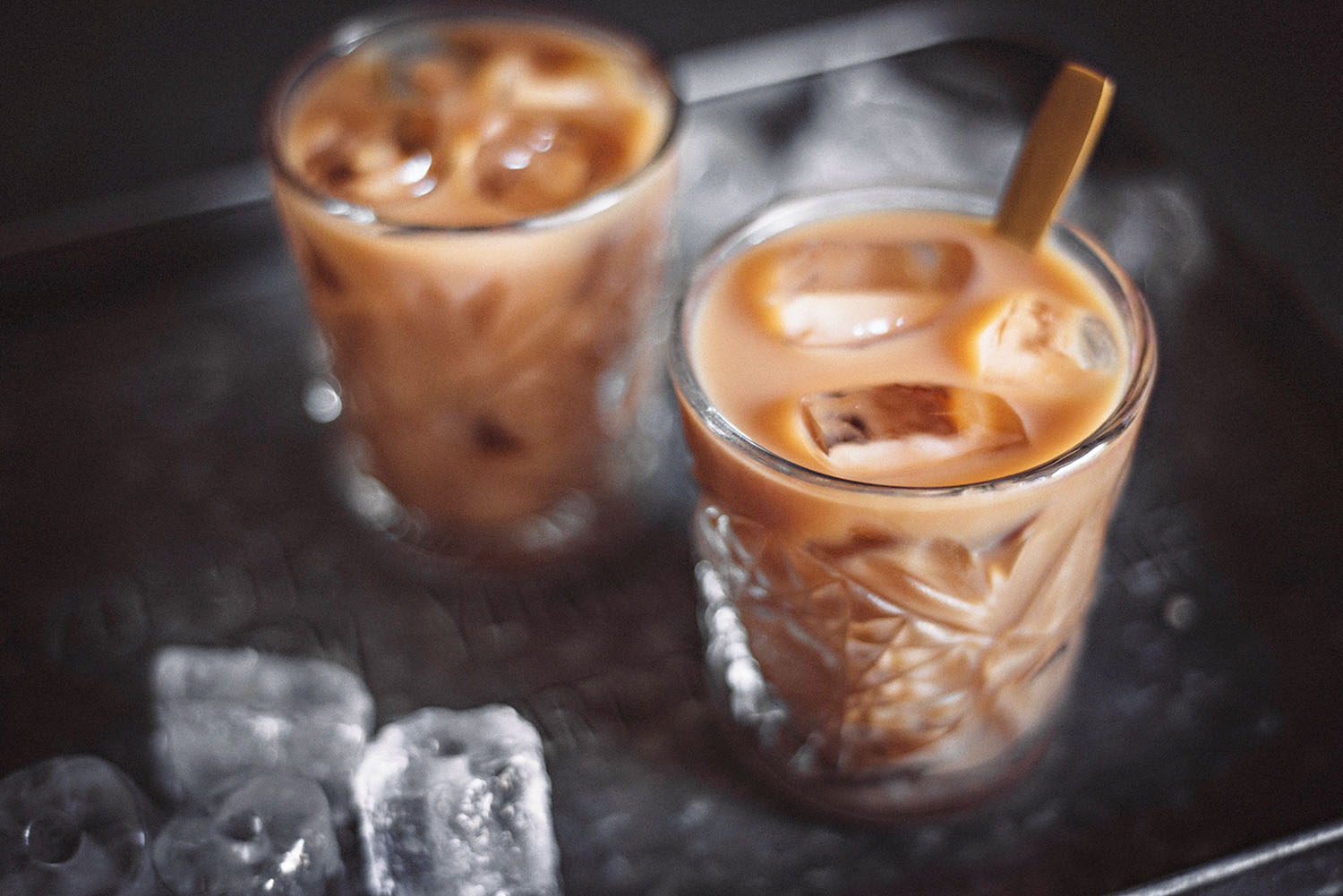 Two glasses with ice coffee and ice