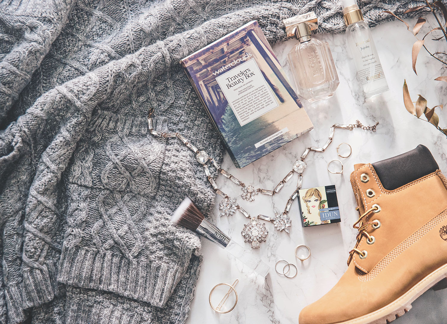 UK Travel Essentials - Flatlay with cosy knit, Timberland & my essentials to United Kingdom