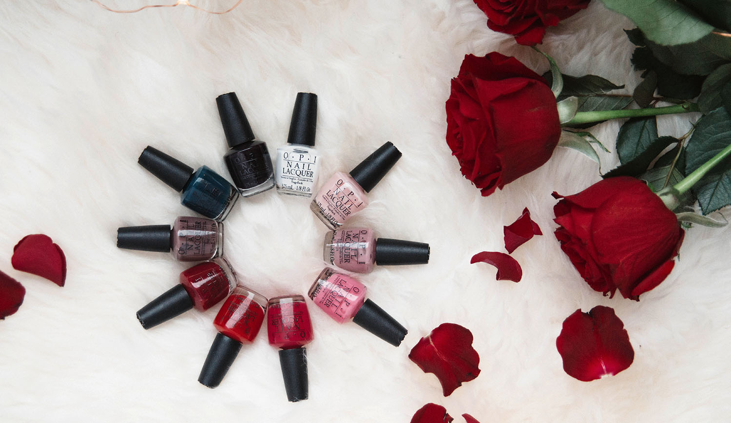 Flatlay with nail polishes from OPI Breakfast at Tiffanys pack and scattered roses