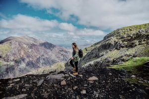 Girl with backpack walking in Clogwyn, Snowdonia National Park in Wales - King Arthur: Legend of the Sword Filming Location in Wales