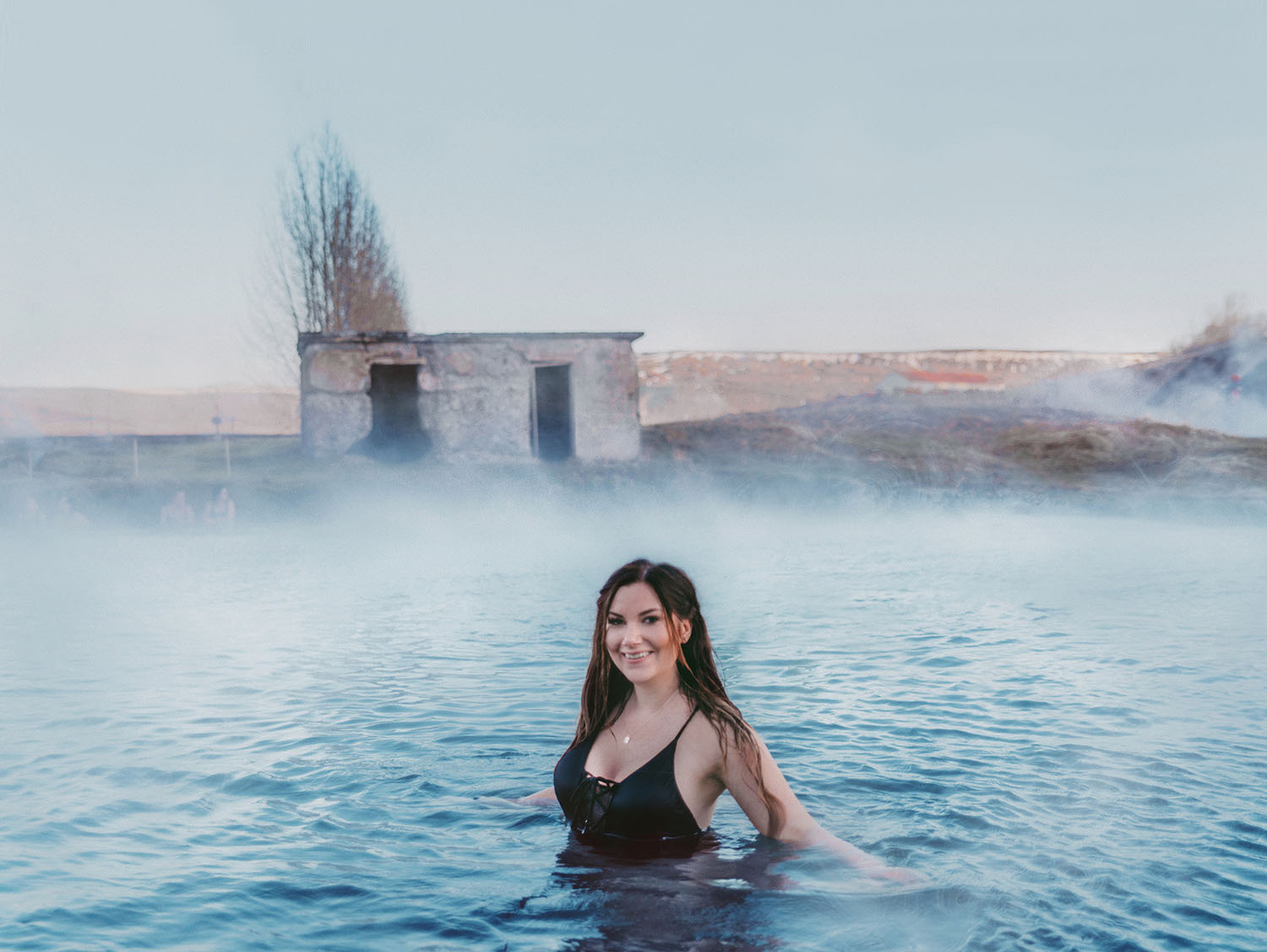 Woman in black Hunkemöller Swimsuit relaxing in Secret Lagoon in Iceland